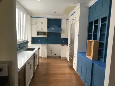 Kitchen remodel showing custom cabinets and tiling