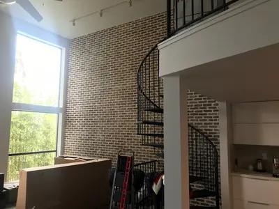 Interior Brick Wall Remodel with Spiral Staircase